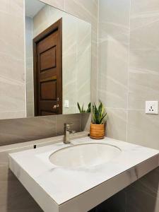 a bathroom with a sink and a mirror at Roya Khmer Homestay in Siem Reap
