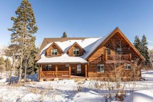 a log cabin with snow on the roof at 8992 STINGER DR DAVENPORT in Wanship