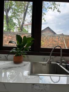a kitchen counter with a sink and a window at Roya Khmer House in Siem Reap +96 photos