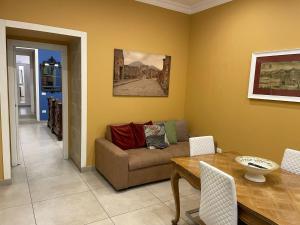 a living room with a couch and a table at Casa Ferdinando apartment in Naples
