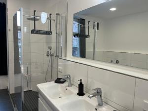 a white bathroom with a sink and a mirror at ChillOut-Oase in Herne +33 photos