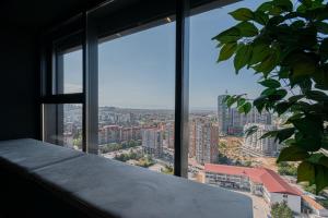 a large window with a view of a city at Presidental Suite in Luxury Hotel at City Center in Pristina