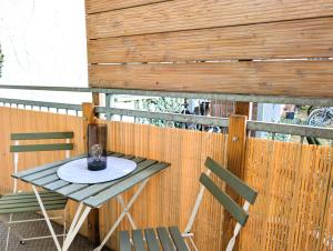 a table and two chairs on a balcony at 5 Personen, familienfreundlich, Waschmaschine, Balkon, Amazon Prime in Magdeburg