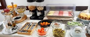 a table with many bowls of food on a counter at Cassia Collection in Rome