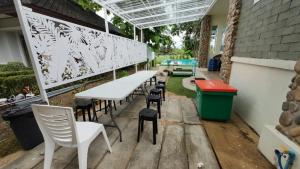 a patio with a white table and chairs at Milky Way Poolvilla in Ban Wang Takhrai