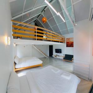 a bedroom with a bunk bed and a staircase at Milky Way Poolvilla in Ban Wang Takhrai +40 photos