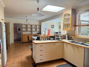 a kitchen with a sink and a counter at Hawker 4BR House in Canberra