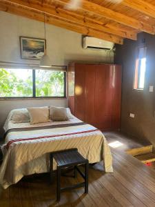 a bedroom with a bed and a table in it at Coruya Wild in Santa Ana