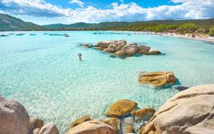 a person swimming in the water near a beach at Bavella in Zonza