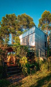 a large metal building sitting on top of a field at Coruya Wild in Santa Ana