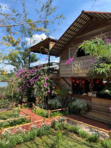 a restaurant with flowers in front of a building at An Homestay in Di Linh