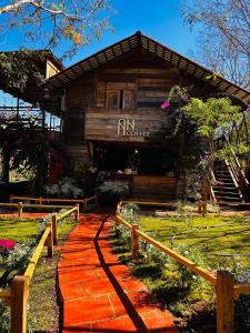 a log cabin with a red walkway in front of it at An Homestay in Di Linh +22 photos
