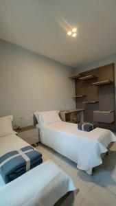 a bedroom with two beds and boxes in it at Luxury Melo Apartment in Bari