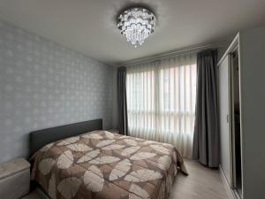 Ένα ή περισσότερα κρεβάτια σε δωμάτιο στο DCondo Hyde Chiang Rai (ดีคอนโด ฮาย เชียงราย)