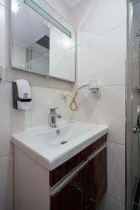 a bathroom with a sink and a mirror at Taksim Asteria Apart in Istanbul +16 photos