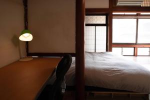 Postel nebo postele na pokoji v ubytování フロント無人管理 コワーキング付き古民家ゲストハウス チェックイン対応不要