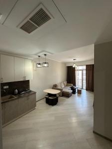a living room with a couch and a table at Tsakhkadzor Getaway 1-3BR Condos with Pool, Near Ropeway & Dining in Tsaghkadzor