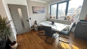 a dining room with a white table and chairs at Marleens Ferienhaus am See in Schwerin +7 photos