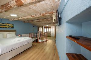 a bedroom with a bed and a blue wall at TaksimAntiqueOtel in Istanbul