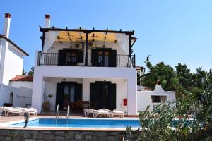 a house with a swimming pool in front of it at Villa Ostria in Alonnisos Old Town