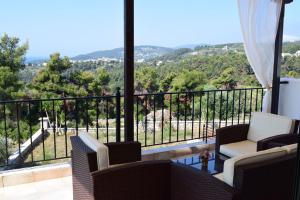 a balcony with chairs and a view of a mountain at Villa Ostria in Alonnisos Old Town