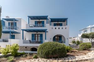 a white house with blue accents at Niriides Boutique Apartments in Koufonisia
