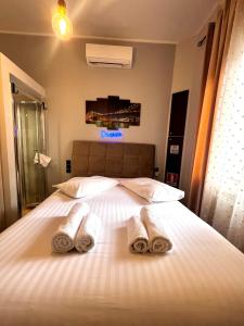 a bedroom with a bed with towels on it at Phoenix Garden Apartments -1- in Athens