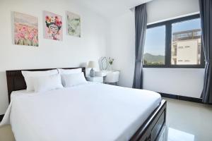 Postel nebo postele na pokoji v ubytování Horizon Côn Đảo Hotel
