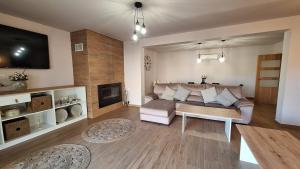 a living room with a couch and a tv at Casa Rural 3 Suspiros in Torre de Santa María