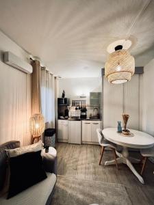 a living room with a couch and a table at La Mienn'oise in Amiens +7 photos