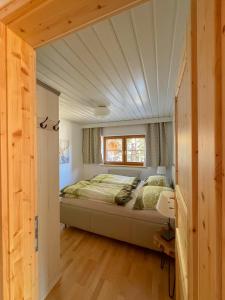 a bedroom with a bed and a window at Landhaus Krappinger in Bad Kleinkirchheim