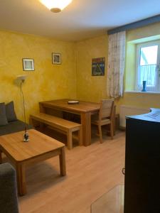 a living room with a table and a couch and a table at Apartment Klara in Stubach +7 photos