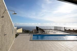 a swimming pool on the roof of a house at Marco 4 Seasons- Winter in Arco da Calheta