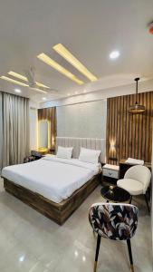a bedroom with a large bed and a chair at Leisure homes in Lucknow
