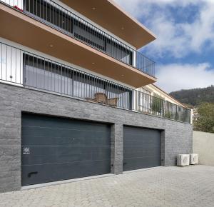a building with two garage doors and a balcony at Marco 4 Seasons- Winter in Arco da Calheta