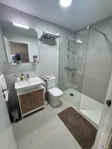 a bathroom with a toilet and a sink and a shower at J&J Luxury Apartments in Estepona