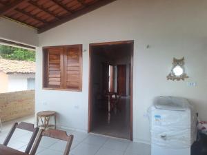 a room with a door and a table and chairs at surfhoster in Paracuru