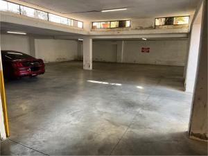 an empty parking garage with a car parked in it at Cassia Collection in Rome