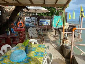 a patio with a table and chairs and an umbrella at JRM Place in Oslob