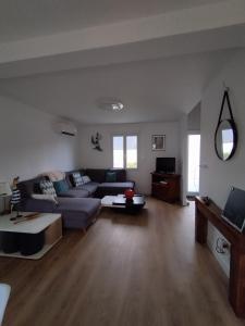 a living room with a couch and a table at Maison de la fontaine in Saint-Méloir-des-Ondes +33 photos