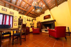 a living room with a table and chairs and a fireplace at B&b Le Case Rosse in Villa Verucchio