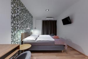 Postel nebo postele na pokoji v ubytování VV hotel & apartments