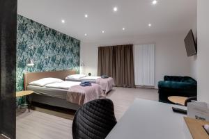 Postel nebo postele na pokoji v ubytování VV hotel & apartments