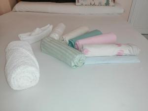 un mucchio di asciugamani su un letto bianco di Loyalty apartment a Dumyat al Jadidah