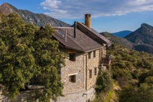 an old stone house on the side of a mountain at Casa Guardafuentes de Ordesa ,Casa del Guardés in Buerba