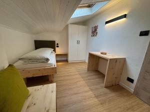 a small room with a bed and a table at Klostergut in Kastelbell-Tschars