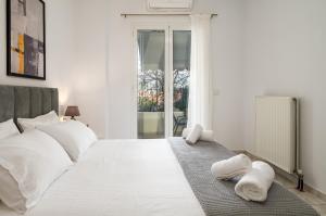 a bedroom with a white bed with towels on it at Ionian Nest in Argostoli