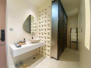 un bagno con lavandino e specchio di Sanqiu Designer B&B a Lijiang