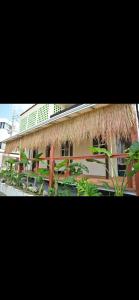 a building with a thatched roof and some plants at BARi OKINAWA in Itoman +7 photos