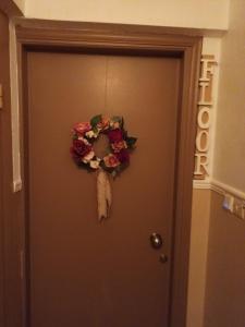 a door with a wreath on it at Floor in Alexandroupoli